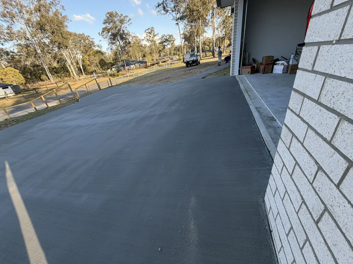 Freshly finished driveway along the side of a garage