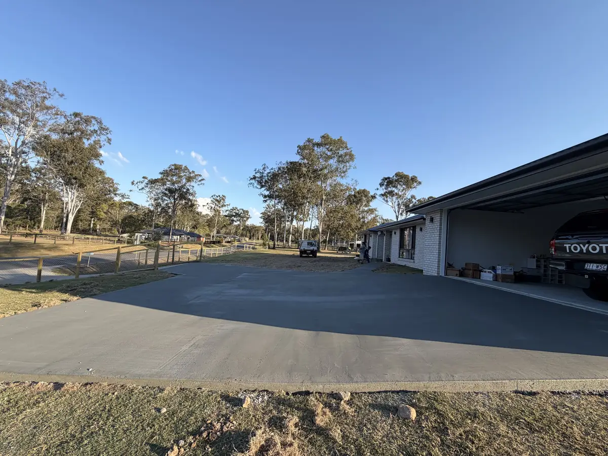 Long concrete driveway finished down to the street