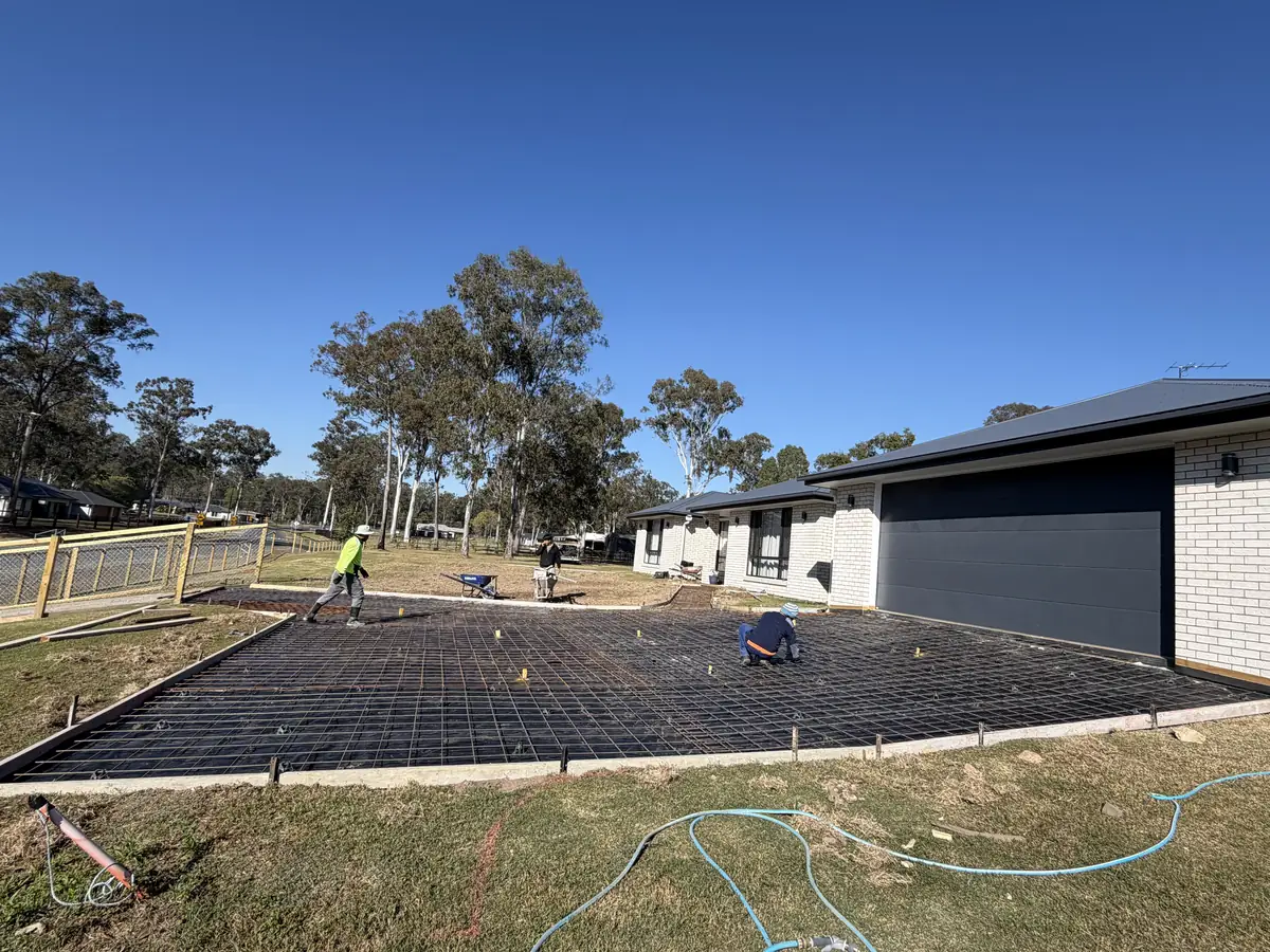 Large driveway laid out with membrane and steel mesh, crew working on it