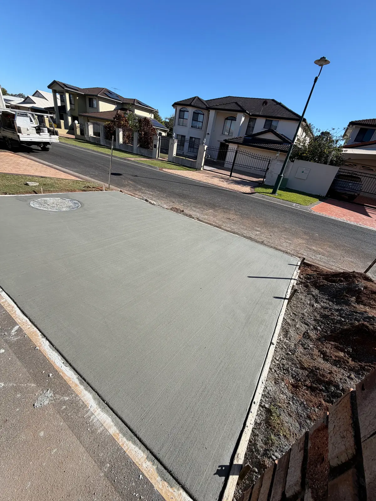 Freshly poured driveway running from the house down to the street