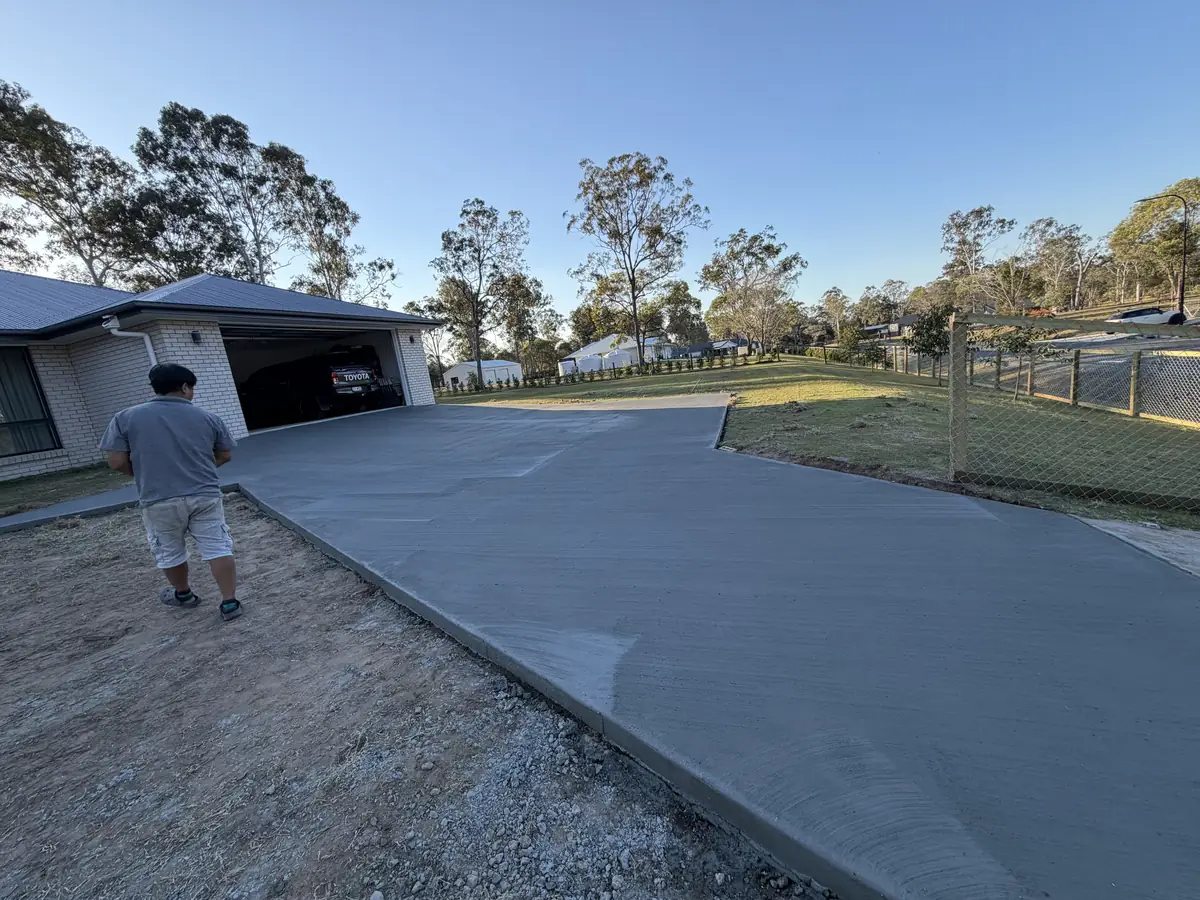 Finished driveway with a person walking up it