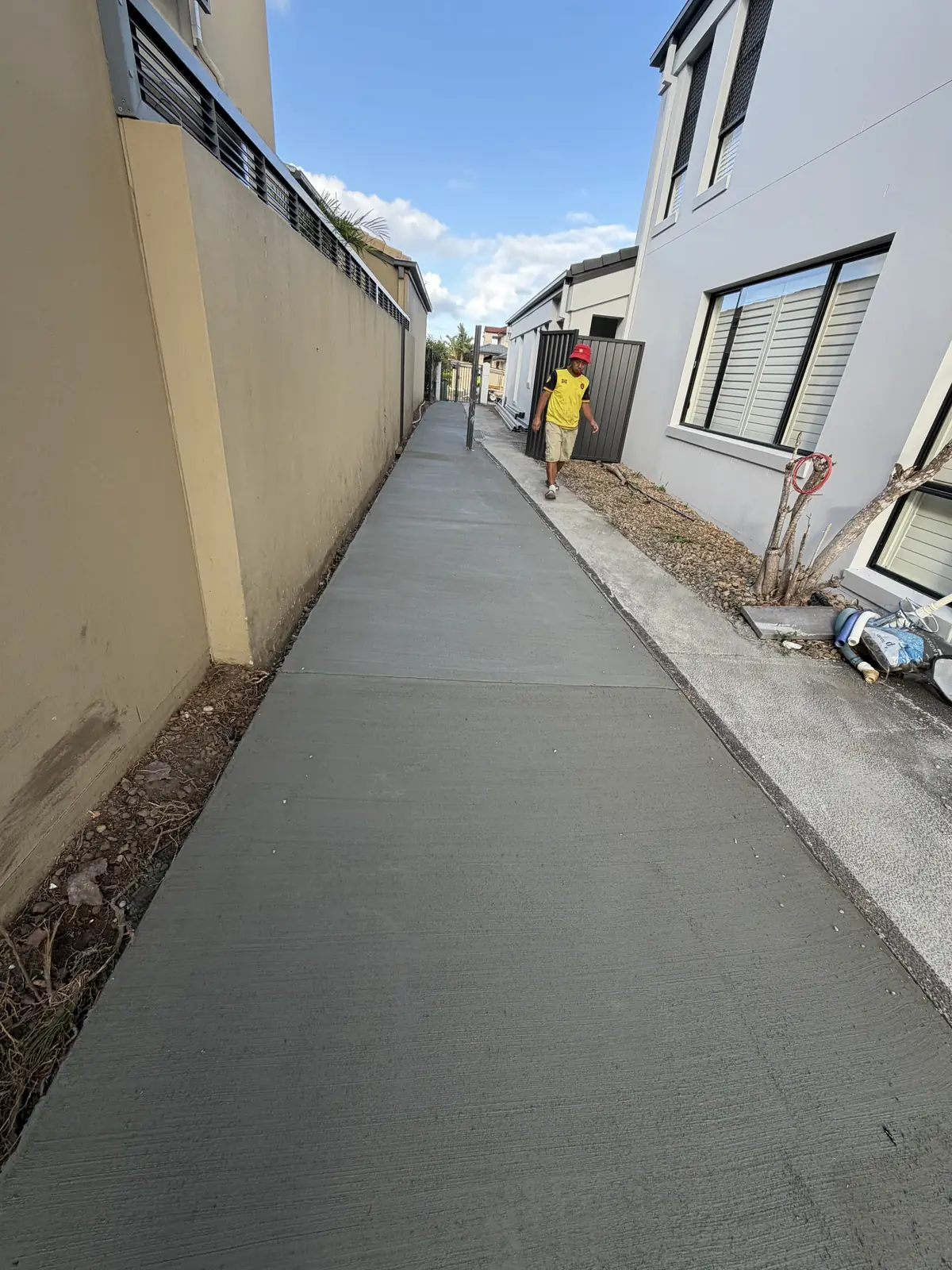 Long side path poured between the house and the boundary wall