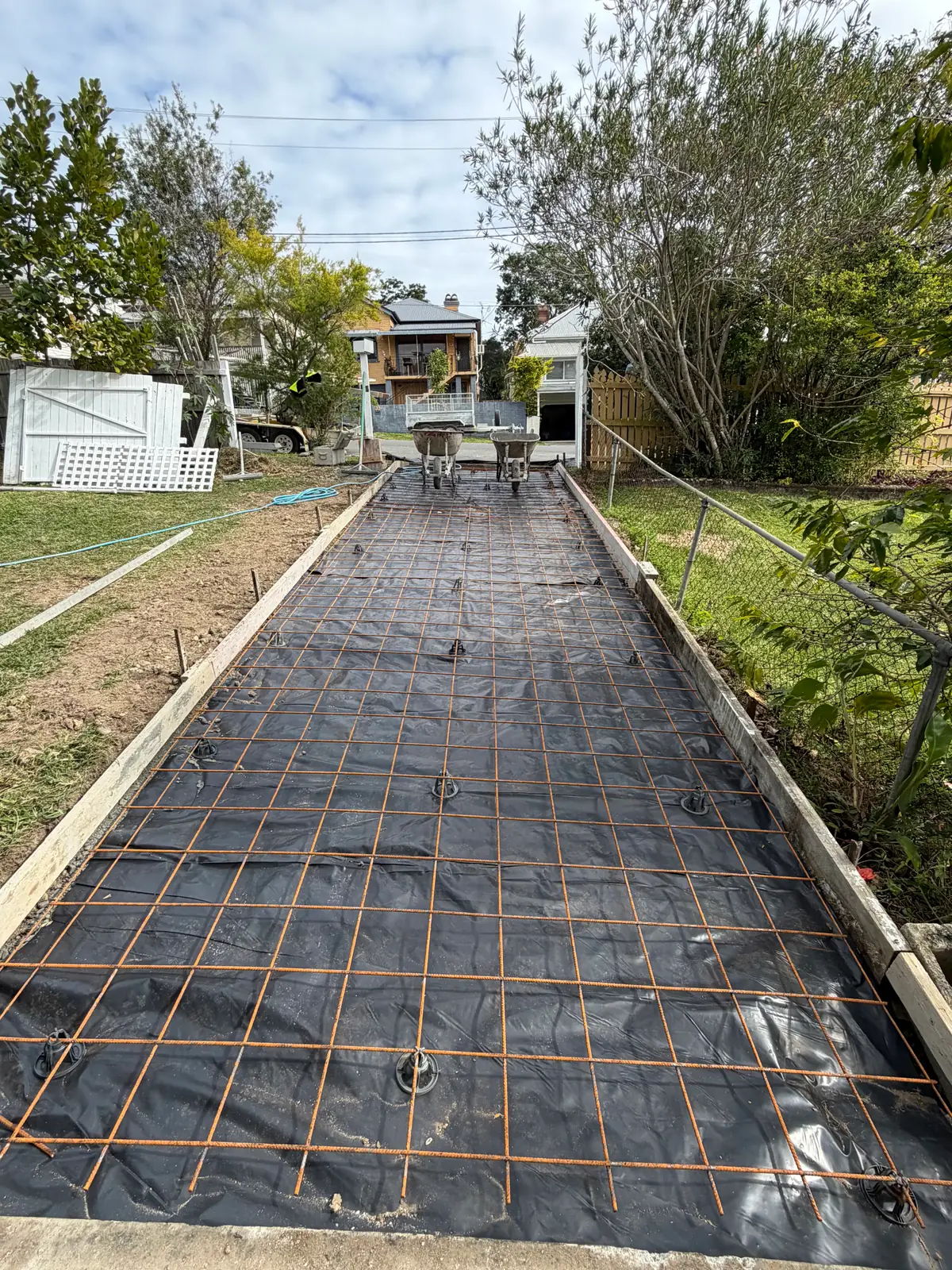 Long path formed up with timber edges, membrane and steel mesh before the pour