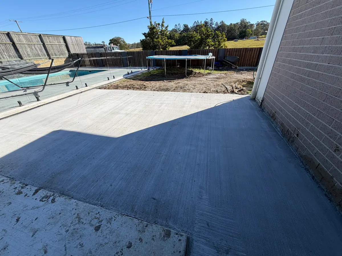 Slab poured along the side of a house next to the pool fence