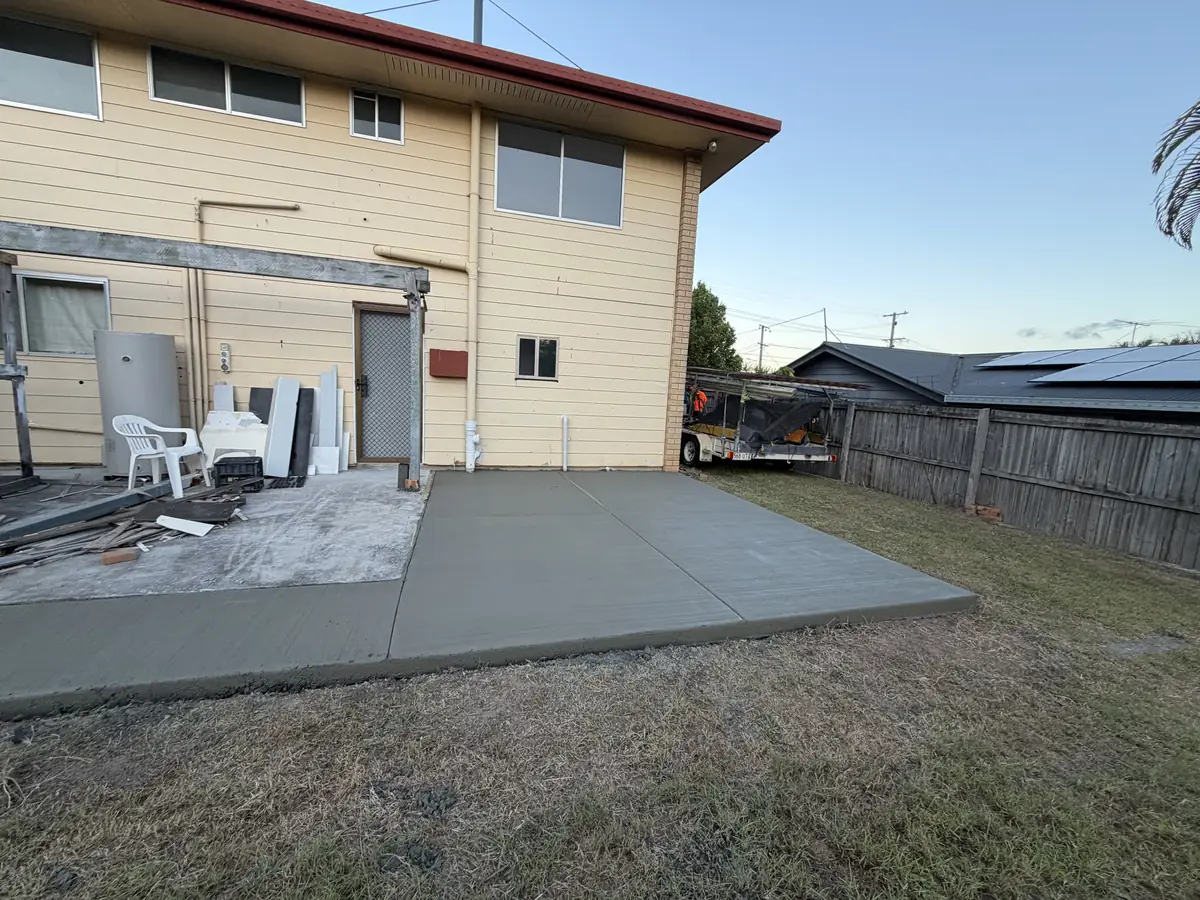 Back yard slab poured behind a two storey house